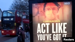 A public health information message is seen at a bus stop in West Ealing as the South African variant of the novel coronavirus is reported in parts of the United Kingdom amid the spread of the coronavirus disease (COVID-19), London, Feb. 1, 2021.