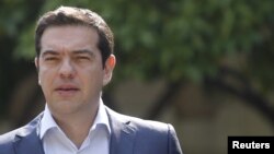 Greek Prime Minister Alexis Tsipras leaves Maximos Mansion to meet with party leaders at the Presidential Palace in central Athens, Greece, July 6, 2015. 