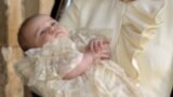 Kate, Duchess of Cambridge carries her son Prince George after his christening at the Chapel Royal in St. James's Palace in London, Oct. 23, 2013.