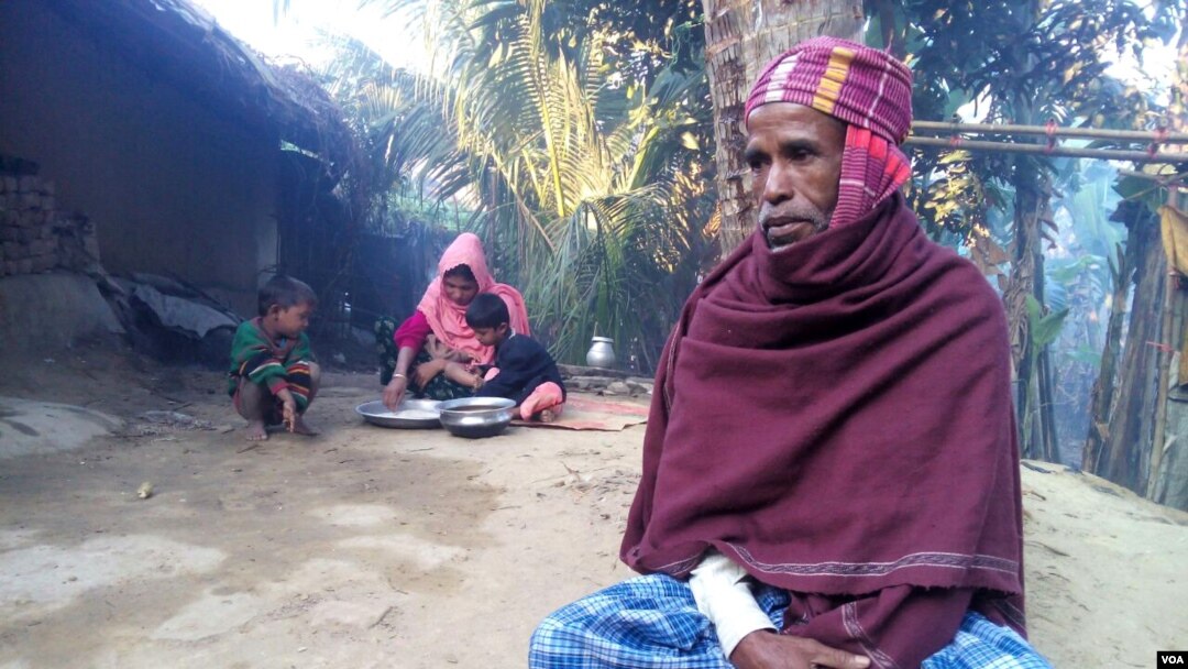 Rohingya Muslim refugee Mohammad Eliyas, with his wife and children, at his Cox's Bazar shanty colony in Bangladesh. With his wife and two children Eliyas fled Myanmar after Burmese soldiers burnt his house, Nov. 2016. (S. Islam for VOA)
