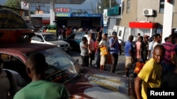 Motorbike riders and car drivers wait to get fuel at a gas station in Port-au-Prince, Haiti, April 7, 2019. 