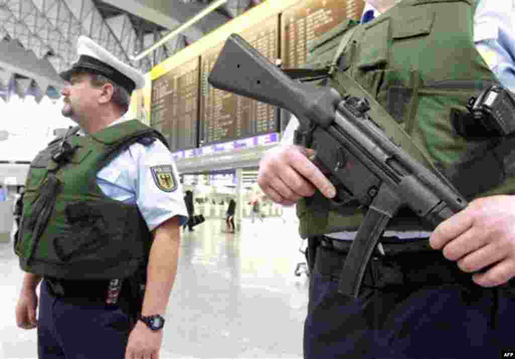 German federal police officers patrol in a departure terminal at the International airport of Frankfurt, central Germany, Wednesday, Nov. 17, 2010. Germany will increase security and vigilance across the country because of a heightened threat from interna