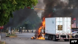 A truck burns in a street of Culiacan, Sinaloa state, Mexico, Oct. 17, 2019.