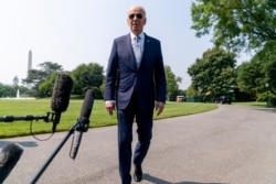 President Joe Biden walks towards members of the media before boarding Marine One on the South Lawn of the White House in Washington, July 7, 2021, for a short trip to Andrews Air Force Base, Md, and then on to Illinois.