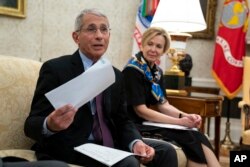 FILE - White House coronavirus response coordinator Dr. Deborah Birx listens as Director of the National Institute of Allergy and Infectious Diseases Dr. Anthony Fauci, left, speaks at the White House, April 29, 2020, in Washington.