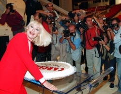 FILE - Raffaella Carra smiles as she poses for photographers during a press conference at Rome's Foro Italico, Sept. 30, 1999.