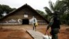 A municipal health worker and an environmental military police officer carry the AstraZeneca/Oxford vaccine as they enter in an Indigenous hut at the the Sustainable Development Reserve of Tupe in the Negro river banks in Manaus, Brazil, Feb. 9, 2021.