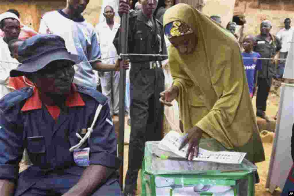 A Muslim woman prepares to vote during a gubernatorial election in Kaduna, Nigeria, Thursday, April 28, 2011. Two states in Nigeria's Muslim north voted Thursday for state gubernatorial candidates after their polls were delayed by violence that killed at 