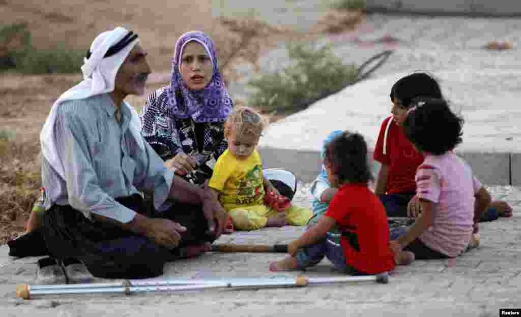 New Syrian refugees rest as they arrive at a stopover facility near the Turkish border town of Reyhanli in Hatay province, August 9, 2012. 