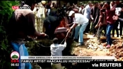 Ethiopian musician Haacaaluu Hundeessaa is buried in Ambo, Ethiopia, July 2, 2020, in this still image from a video.