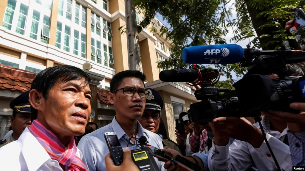 FILE - Uon Chhin and Yeang Sothearin, former journalists for U.S.-funded Radio Free Asia (RFA), speak to the media in front of the Municipal Court of Phnom Penh, in Phnom Penh, Cambodia, Oct. 3, 2019.