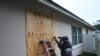 A resident boards up his windows in Palm Harbor, Florida, ahead of Hurricane Milton's expected mid-week landfall on Oct. 6, 2024. 