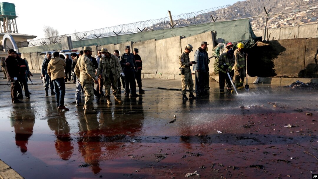 Afghan security forces inspect the site of a suicide attack at the gate of a Civil Order Police compound, in Kabul, Afghanistan, Feb. 1, 2016. 