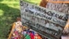 FILE - A makeshift memorial for the dozens of Indigenous children who died more than a century ago while attending a boarding school that was once located nearby is growing under a tree at a public park in Albuquerque, New Mexico, July 1, 2021. 