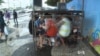 Fans are out, under the umbrellas of the ocean-side cafes, watching the day’s games, or listening to them on the radio under some scaffolding, but the rain has kept most people inside.