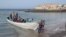 FILE - This handout photograph released by the Spanish Red Cross (Cruz Roja) on July 13, 2023 shows a boat arriving at Las Galletas beach in the municipality of Arona, on the Canary Island of Tenerife.