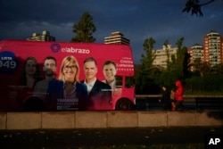 A bus emblazoned with a campaign ad promoting Frente Amplio presidential candidate Yamandu Orsi drives by ahead of Sunday's general election, in Montevideo, Uruguay, Oct. 25, 2024.