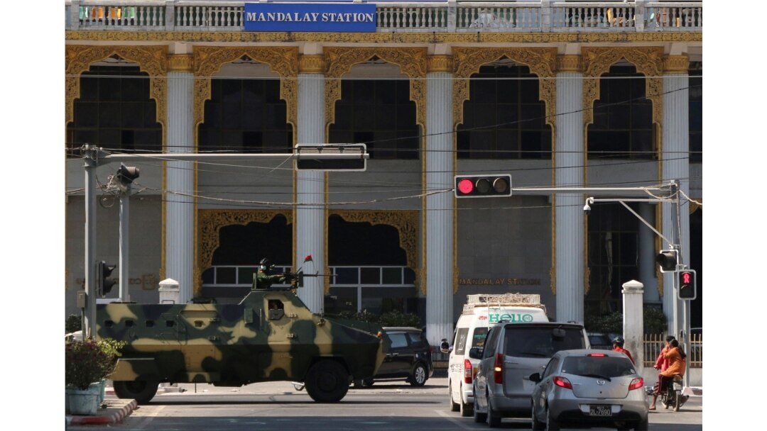 Myanmar military vehicles drive past a street after they seized power in a coup in Mandalay, Myanmar, Feb. 2, 2021.