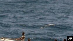 In this photo provided by the U.S. Navy, pirates leave the Ukrainian merchant vessel MV Faina for Somalia's shore Wednesday, Oct. 8, 2008 while under observation by a U.S. Navy ship. The MV Faina which is carrying a cargo of Ukrainian T-72 tanks and relat