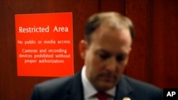 FILE - A sign marks a door to a secure area behind Rep. Lee Zeldin, R-N.Y., as he speaks with members of the media regarding the closed-door House impeachment inquiry into President Donald Trump in Washington, Oct. 23, 2019. 