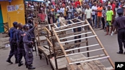 FILE - Liberia security forces blockade an area around the West Point Ebola center as the government clamps down on the movement of people to prevent the spread of the Ebola virus in Monrovia, Liberia, Aug. 20, 2014. 