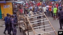 FILE - Liberia security forces blockade an area around the West Point Ebola center as the government clamps down on the movement of people to prevent the spread of the Ebola virus in Monrovia, Liberia, Aug. 20, 2014. 