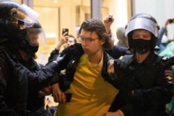 Police officers detain a protester during a rally to cancel the results of voting on amendments to the Constitution in Moscow, Russia, July 15, 2020.