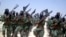 FILE - Al-Shabab fighters are seen marching with their weapons during exercises on the outskirts of Mogadishu, Somalia, Feb. 17, 2011. U.S. forces conducted "defensive fire" against the militants, after Ugandan African Union troops came under attack near Mogadishu, a U.S. defense official told VOA.