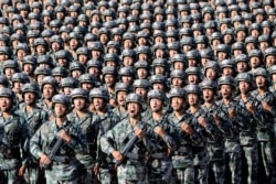 FILE - Soldiers of China's People's Liberation Army get ready for the military parade to commemorate the 90th anniversary of the foundation of the army at Zhurihe military training base in Inner Mongolia Autonomous Region, China, July 30, 2017.