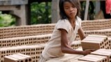 A Cambodian girl prepares bricks to dry under the sun light at a brick factory in Chheuteal village, Kandal province, some 27 kilometers (17 miles) north of Phnom Penh, Cambodia, file photo. 