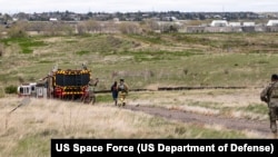 FILE - Emergency responders participate in an exercise at Buckley Space Force Base, Colorado, May 10, 2024.