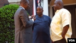 Rep Togba Mulbah (R) and George Mulbah (C) speak with VOA's James Butty (L)