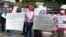 Former beer promoters on August 5, 2015 staged a strike in front of Anco Brother Co., Ltd by showing banners demanding that the company compensate them for their dismissal which allegedly was illegaly by Cambodia's Labor Law. (Courtesy of Cambodian Food and Service Federation)