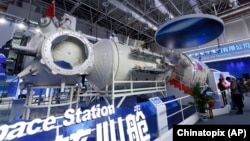 Life-size model of the Tianhe core module at the Airshow China on Nov. 7, 2018. While China admits it arrived late to the space station game, it says its new station is modern and includes the latest space technology. (Chinatopix via AP)