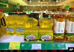 FILE - Bottles of canola oil made by Canadian agribusiness firm Richardson International are seen on a store shelf in China, March 6, 2019. The Trump administration will be implementing 25% tariffs on Canadian goods coming into the U.S. on Feb. 1, 2025.