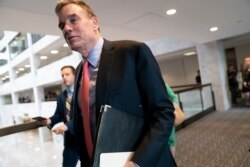 FILE - Senate Intelligence Committee Vice Chair Mark Warner, D-Va., departs after a meeting on Capitol Hill in Washington, May 9, 2019.