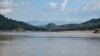 A yellow flag marks the site on the Mekong River in northern Laos where the government plans to build the Luang Prabang hydropower dam. (Zsombor Peter/VOA)