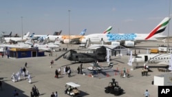 People visit planes during the opening day of the Dubai Airshow, in Dubai, United Arab Emirates, Nov. 17, 2019. 