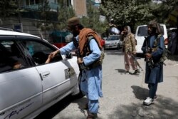 Taliban fighters stand guard at a checkpoint in Wazir Akbar Khan in the city of Kabul, Afghanistan, Aug. 18, 2021.