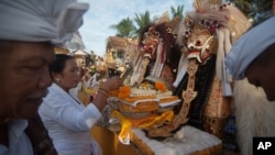 FILE - Balinese Hindu prepare for a procession during a Melasti purification ceremony ahead of the holy day of Nyepi, on Purnama Beach, Gianyar, Bali, Indonesia March 14, 2018 in this photo taken by Antara Foto. 