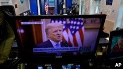 President Trump is seen on a network monitor after his pre-recorded farewell speech was released, inside the Brady Press Briefing Room at the White House, Tuesday, Jan. 19, 2021, in Washington. (AP Photo/Gerald Herbert)