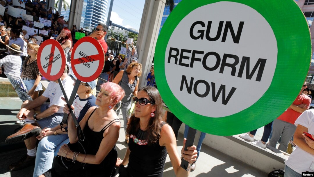 Protesters hold signs as they call for a reform of gun laws three days after the shooting at Marjory Stoneman Douglas High School, at a rally in Fort Lauderdale, Florida, Feb. 17, 2018. 