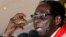 Zimbabwe's President Robert Mugabe gestures as he speaks during an event marking his 89th birthday in Bindura, about 90 km north of the capital Harare Mar. 2, 2013. 