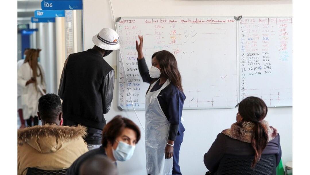 A health worker talks to a vaccine trials' volunteer before he is tested for COVID-19 and takes part of the country's human clinical trial for potential vaccines at the Wits RHI Shandukani Research Centre in Johannesburg, South Africa, Aug. 27, 2020.