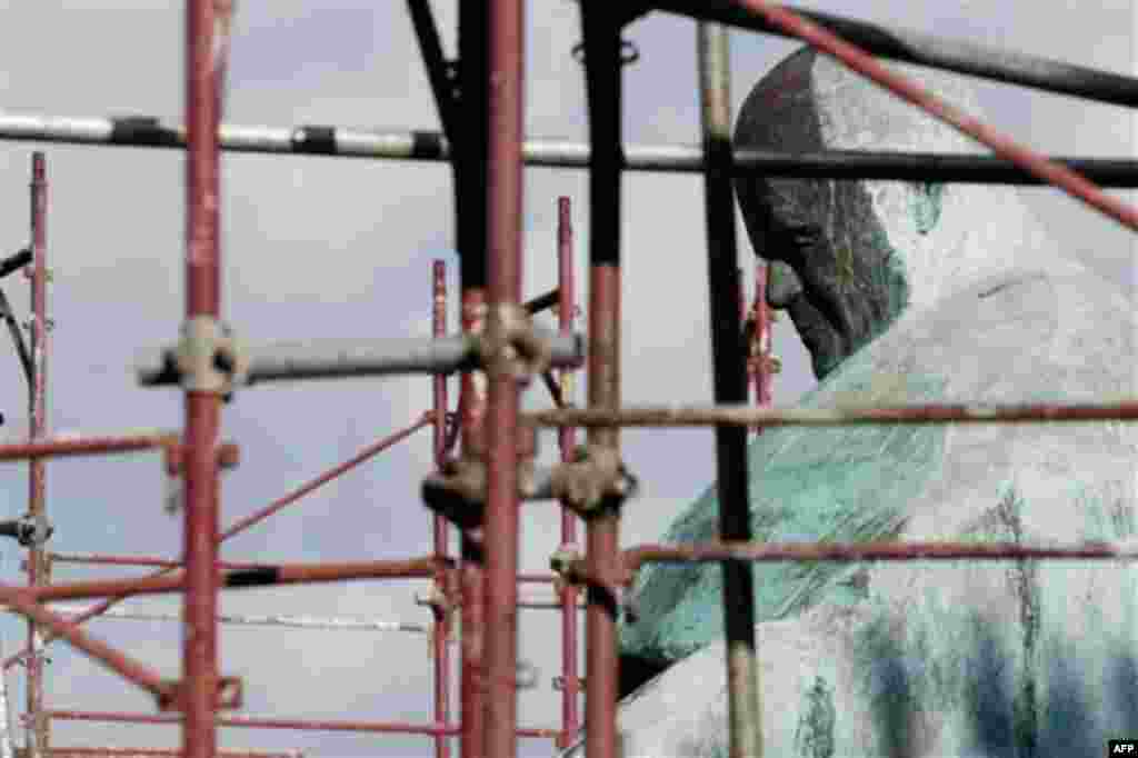Scaffoldings frame the bronze statue of Pope John Paul II by Italian sculptor Oliviero Rainaldi, as its restoration started in Rome, Friday, Jan. 13, 2012. Rainaldi was criticized by the Vatican for creating a sculpture of Pope John Paul II that some mock