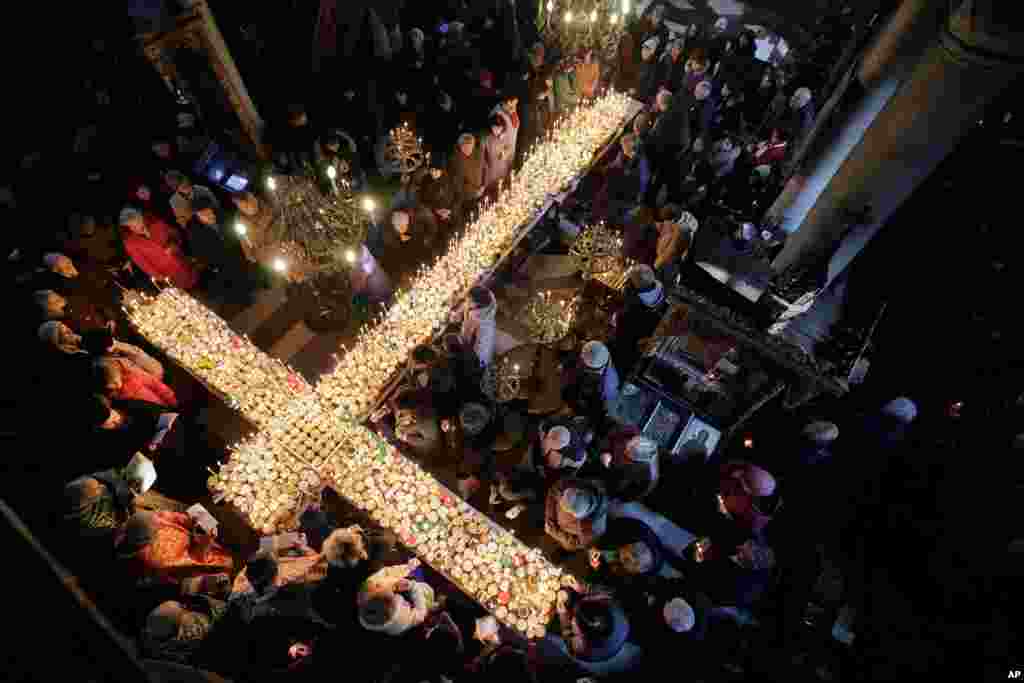 Worshipers gather around candles during a Mass for the &#39;sanctification of honey&#39; at the Presentation of the Blessed Virgin church in the town of Blagoevgrad, some 100 km (62 miles) south of the Bulgarian capital.