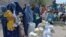 Afghan women receive food donations as part of the World Food Program (WFP) for displaced people, during the Islamic holy month of Ramadan in Jalalabad, Apr. 20, 2021.
