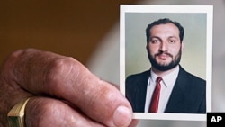 The mother of Palestinian journalist Samer Allawi, head of Al-Jazeera's Kabul office, holds a picture of him at his family house in the village of Sebastia in the West Bank after Israel arrested Allawi, as he tried to cross to Jordan from the West Bank, w