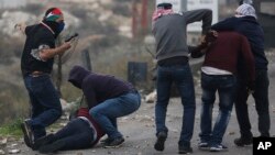 Undercover Israeli police arrest Palestinian demonstrators during clashes following protests against U.S. President Donald Trump's decision to recognize Jerusalem as the capital of Israel, in the West Bank city of Ramallah, Dec. 13, 2017.