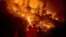 Firefighters monitor a backfire while battling the Ranch Fire, part of the Mendocino Complex Fire near Ladoga, California.